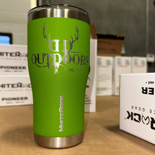 Green White Rock insulated tumbler with deer antler logo and 'DP Outdoors' text on a wooden surface