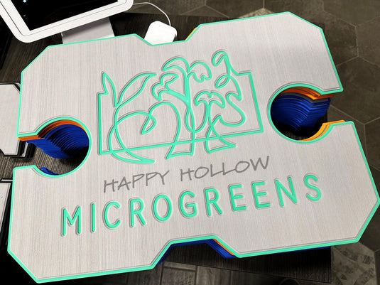 Custom engraved sign for Happy Hollow Microgreens with green outline and plant design
