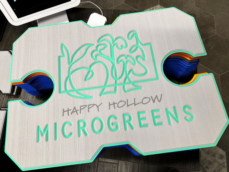 Custom engraved sign for Happy Hollow Microgreens with green outline and plant design