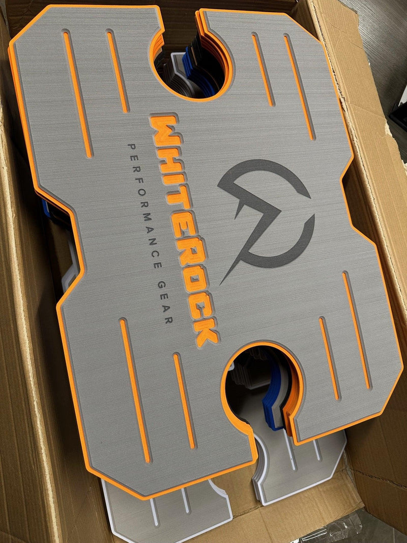 Load image into Gallery viewer, WhiteRock Performance Gear gray and orange rubber sample pad in a cardboard box
