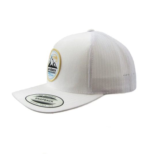 White snapback mesh trucker hat with mountain patch and curved brim