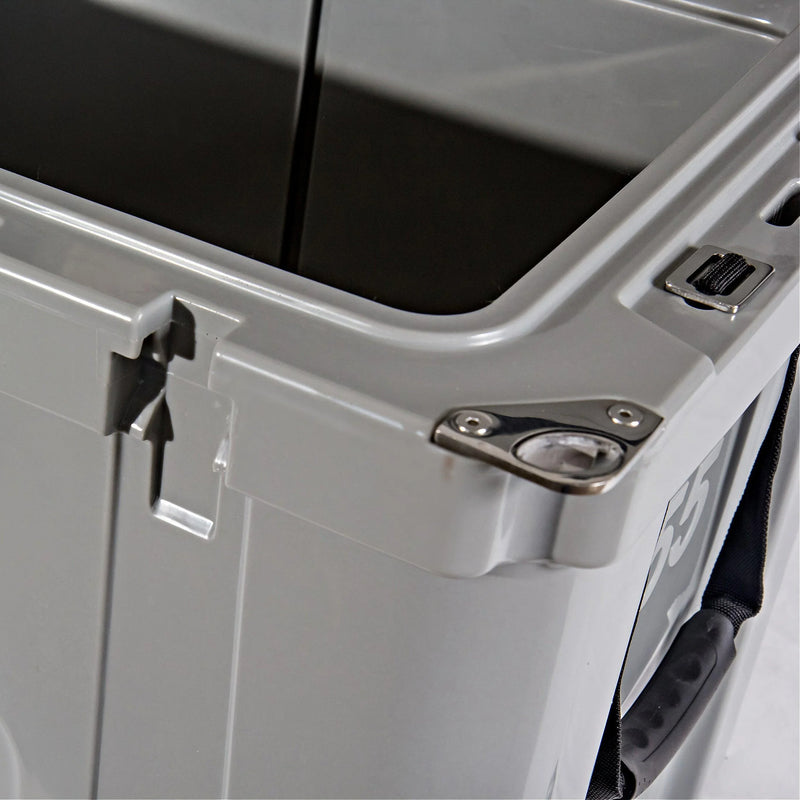 Load image into Gallery viewer, Close-up of gray hard-sided cooler corner with built-in stainless steel bottle opener and black handle
