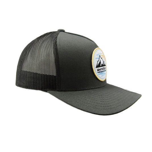 Black mesh trucker hat with curved brim and mountain logo patch on front